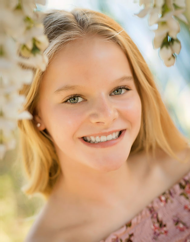 girl-smiling-outside-flowers